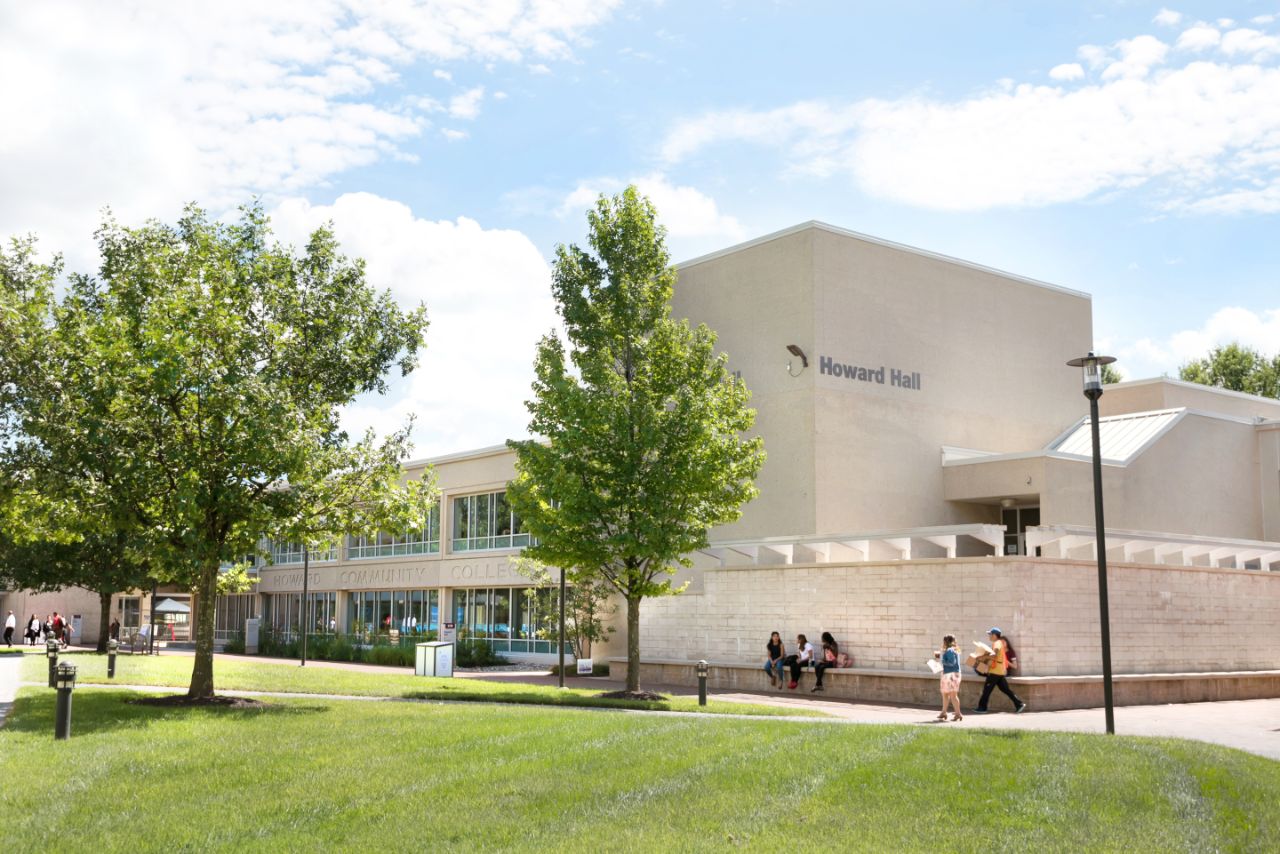 Campus Building named Howard Hall. There are trees in front of the building.