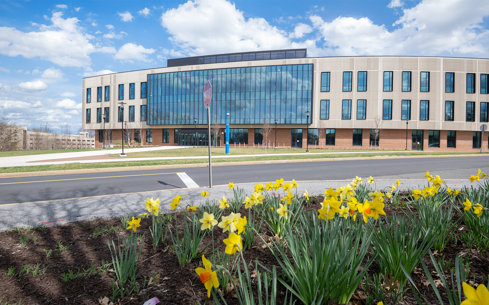 View of the the Front of the Kahlert Complex with flowers in front of the buliding