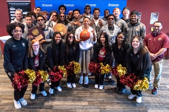 Dr. Willis with basketball team and cheerleaders