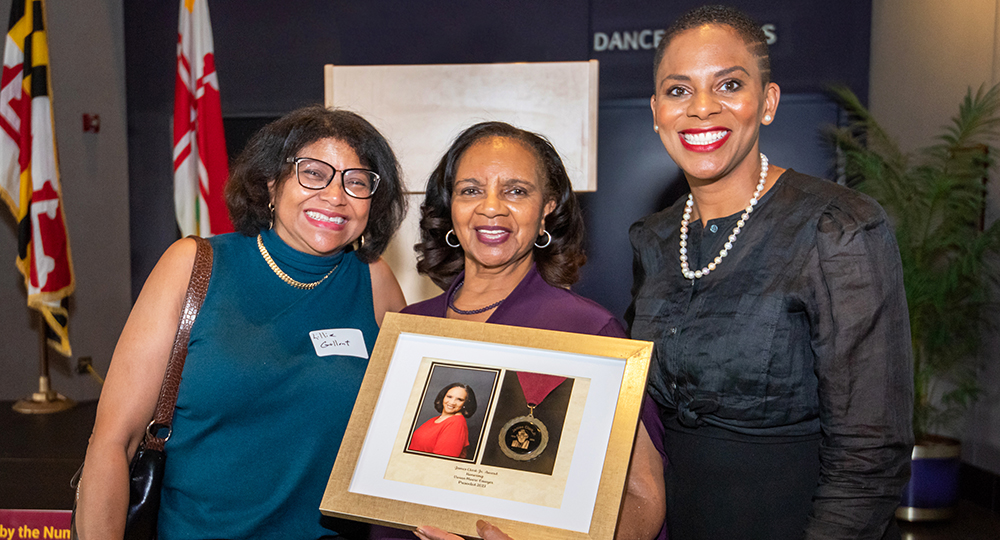 Community Reception 2023 Dr Daria J Willis and Vivian Moore Lawyer, although with another person holding a certificate