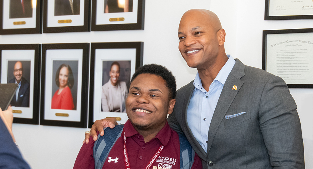 Governor Wes Moore standing next to a student
