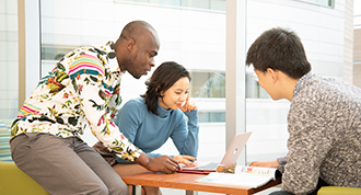 Students collaborating at a table during an English language class