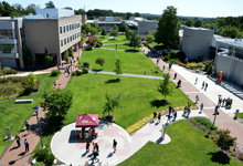 Aerial view of Howard Community College quad with triangular lawn, intersecting walkways, and surrounding academic buildings