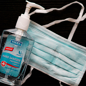 PHOTO OF HAND SANITIZER AND MASK
