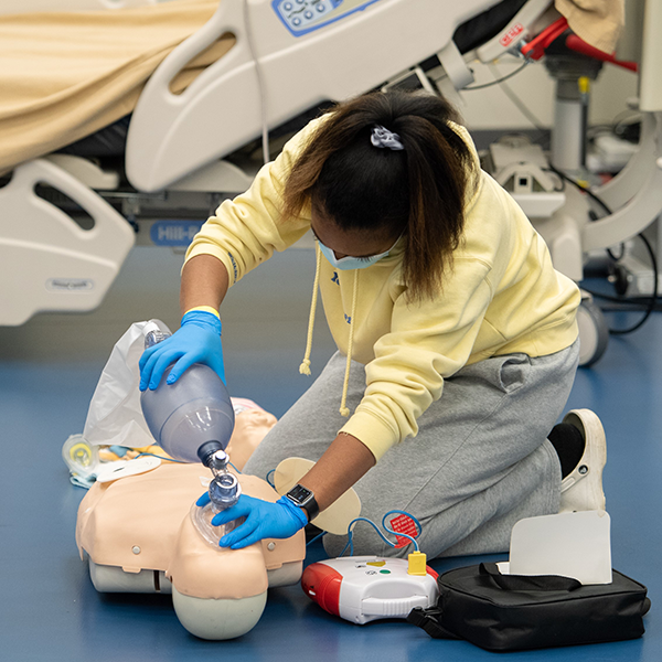 CPR training student and dummy