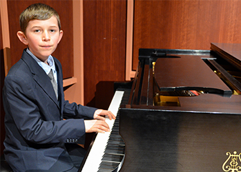 Young child taking piano lessons