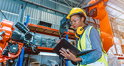 A manufacturing technology student studying in a lab setting.