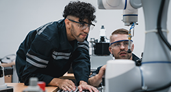 Two students learning in a mechatronics skilled trades lab setting.