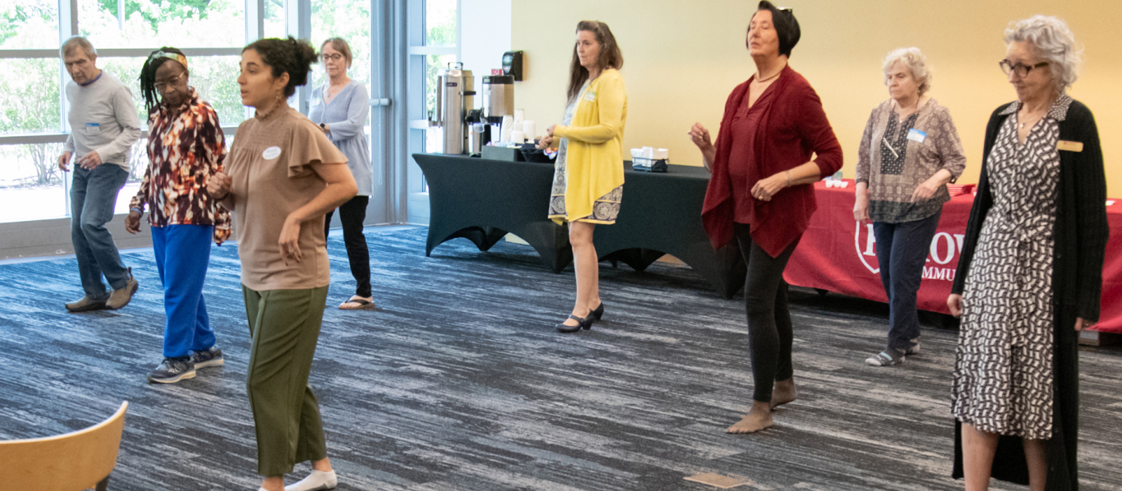 Several adults participating in an active session during the OASIS program.