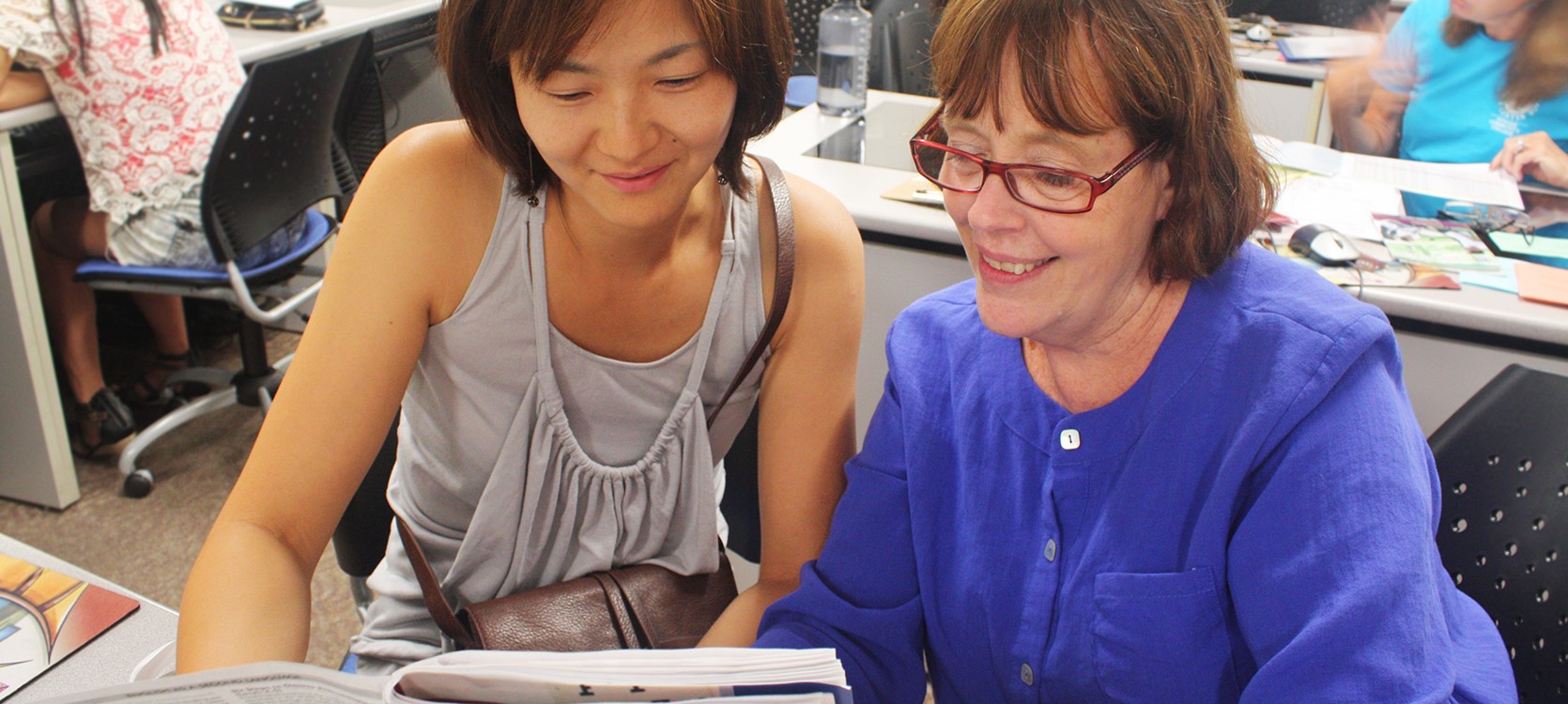a student filling out a registration form with an advisor