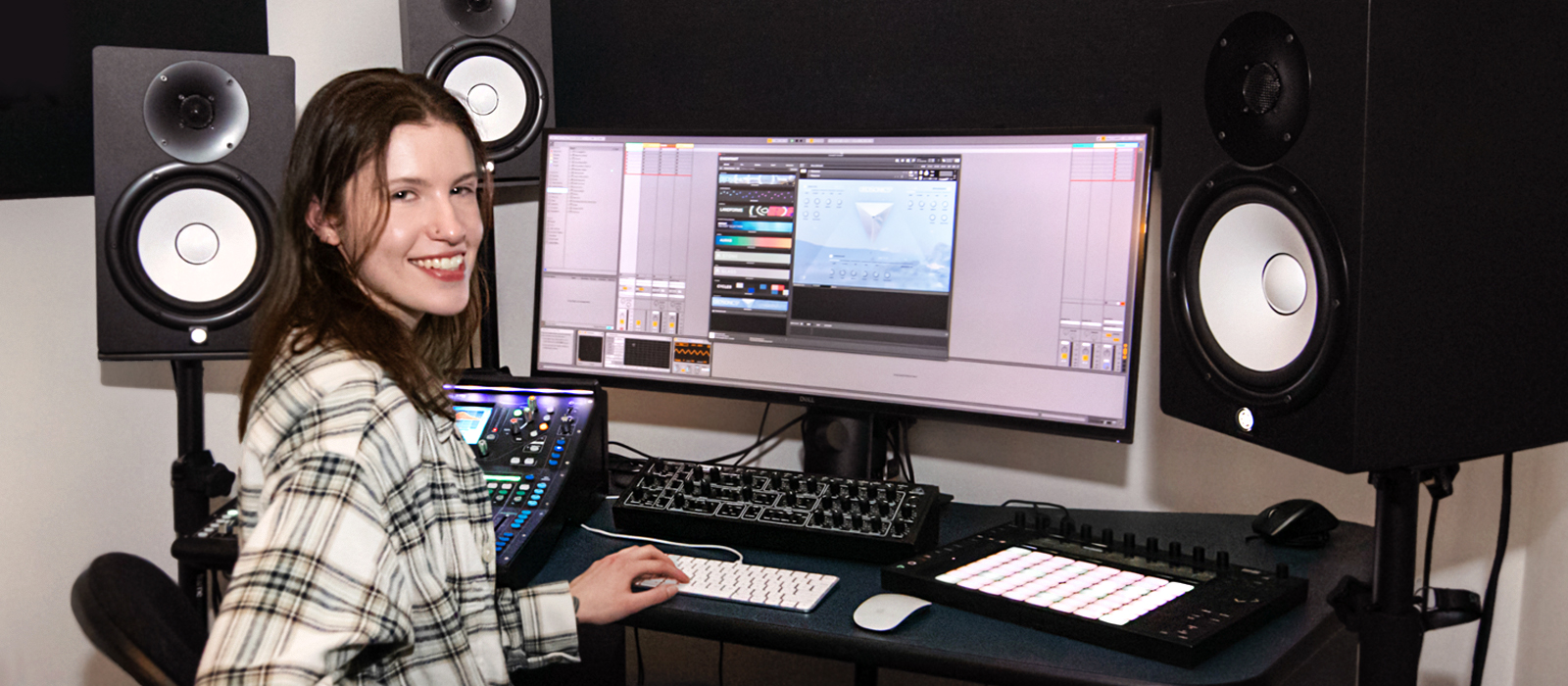 Student sitting at a desk with Audio Video Media Production equipment
