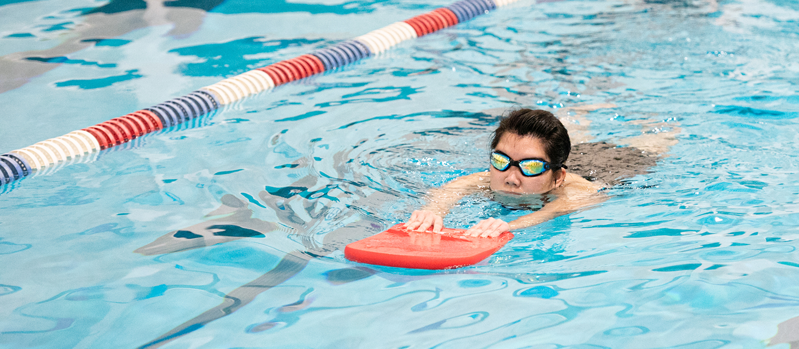 Student swimming in a pool with a pool