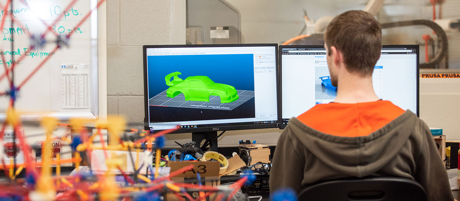 Student sitting in front of a computer using graphics software