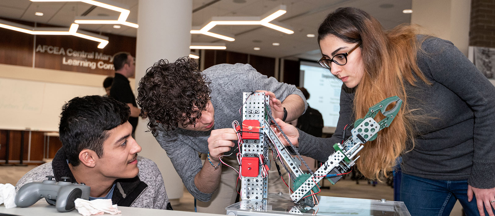 Three students working on an engineering project