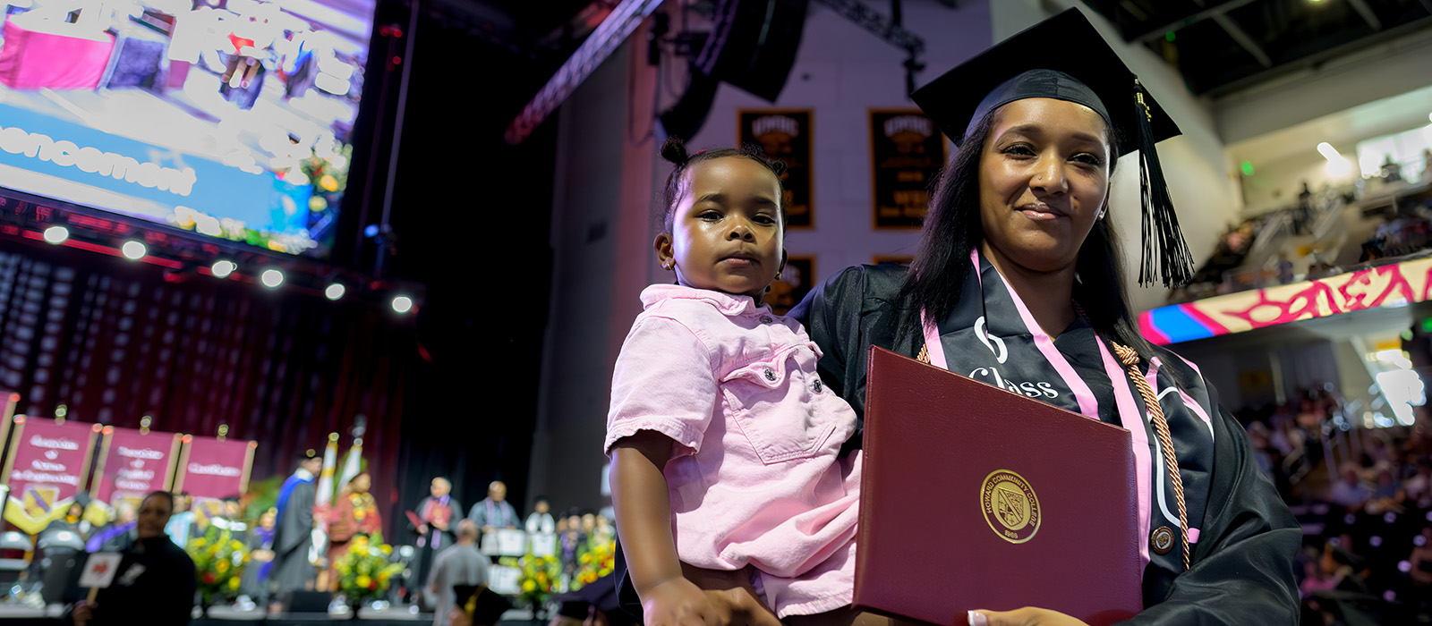 Parent Scholar with their child at the commencement ceremony.