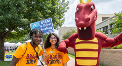 Two students wearing orange 